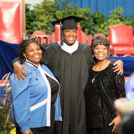 Graduate taking picture with family